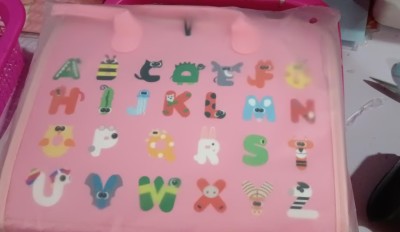 a pink bag with cartoon letters on it