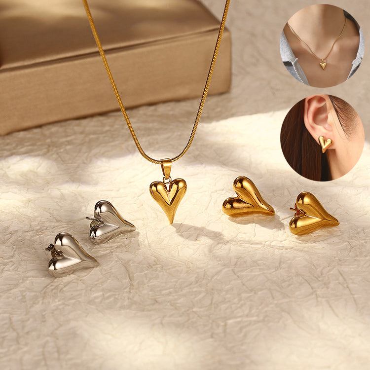 a gold heart necklace and earrings