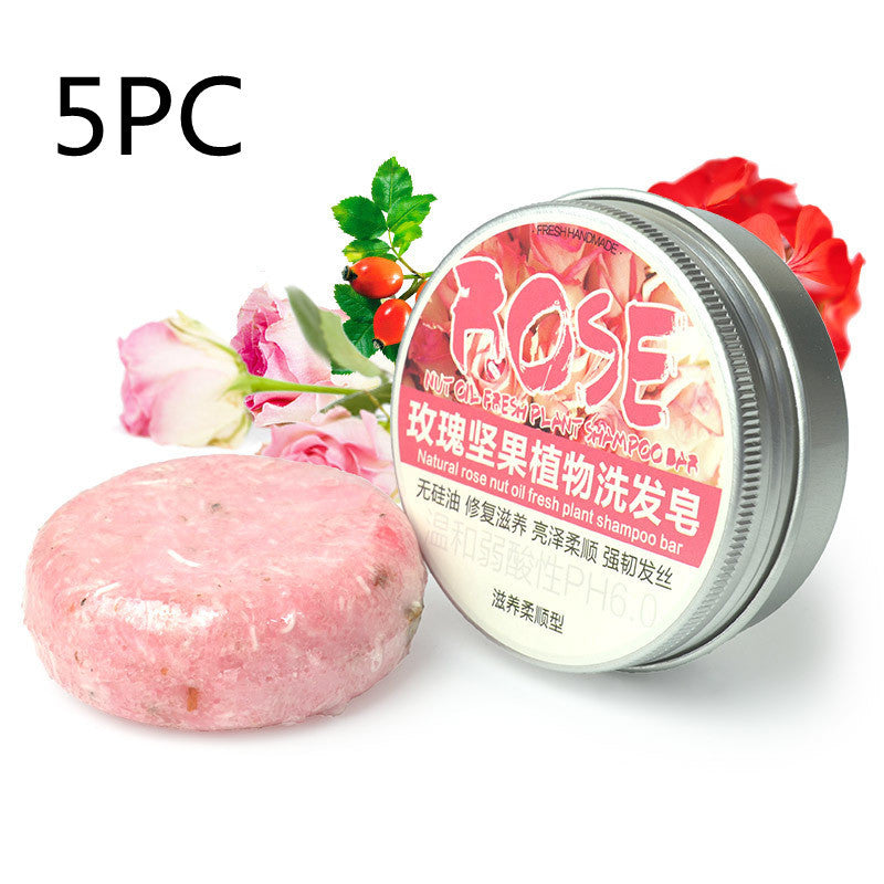 a jar of pink soap next to a pink flower