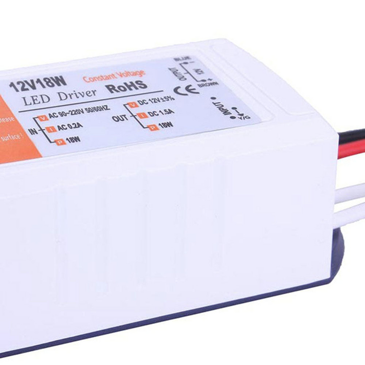 a white electrical device with red and black wires