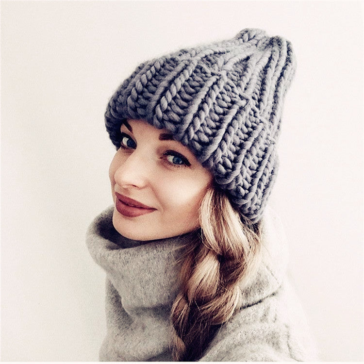 a woman wearing a knit hat and sweater