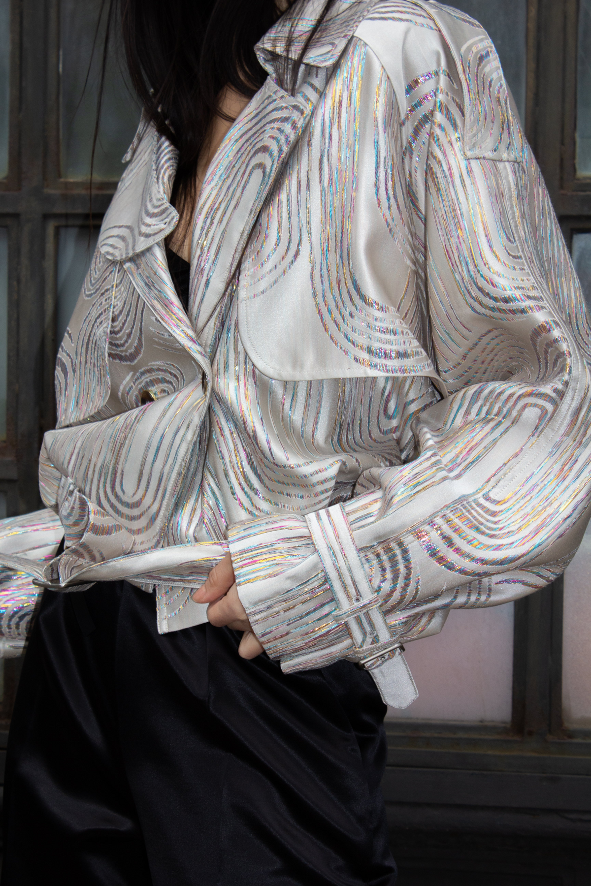 a person wearing a silver shirt