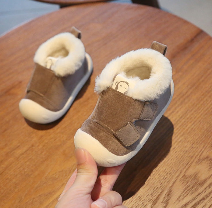 a pair of baby shoes on a table