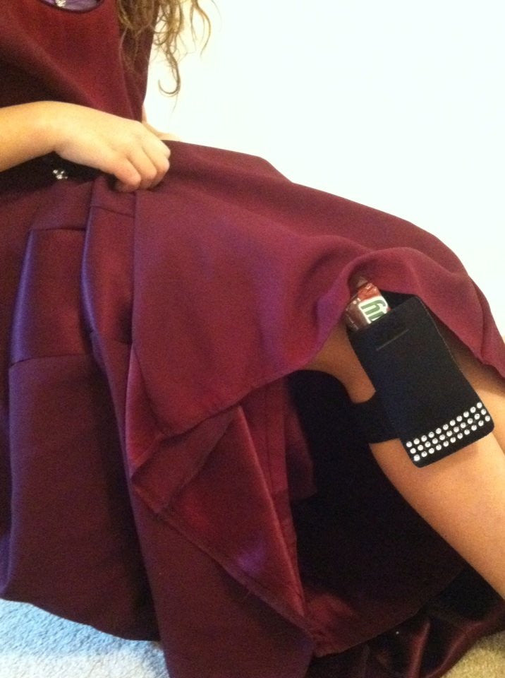 a woman in a dress with a cell phone in her pocket