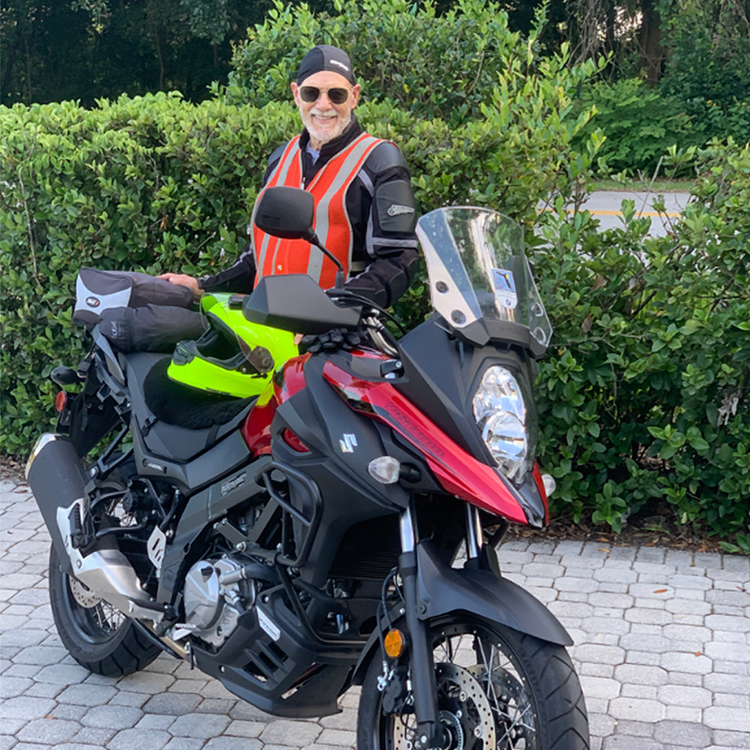 a man standing on a motorcycle