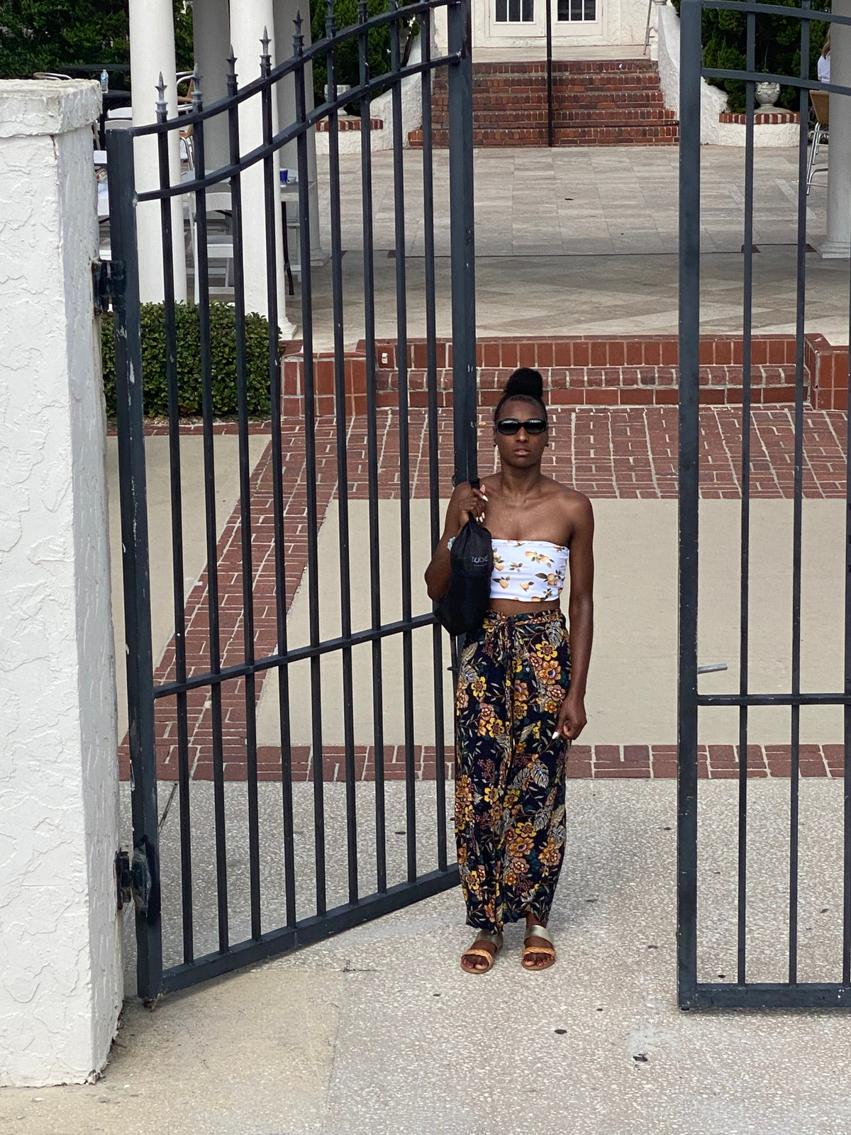 a woman standing in front of a gate