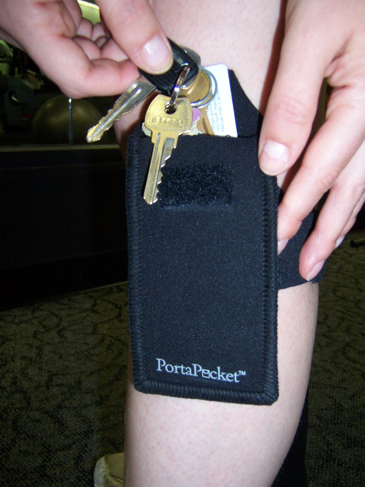 a person holding keys in their pocket