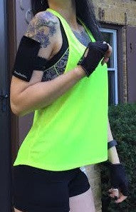 a woman wearing a neon green shirt and black gloves
