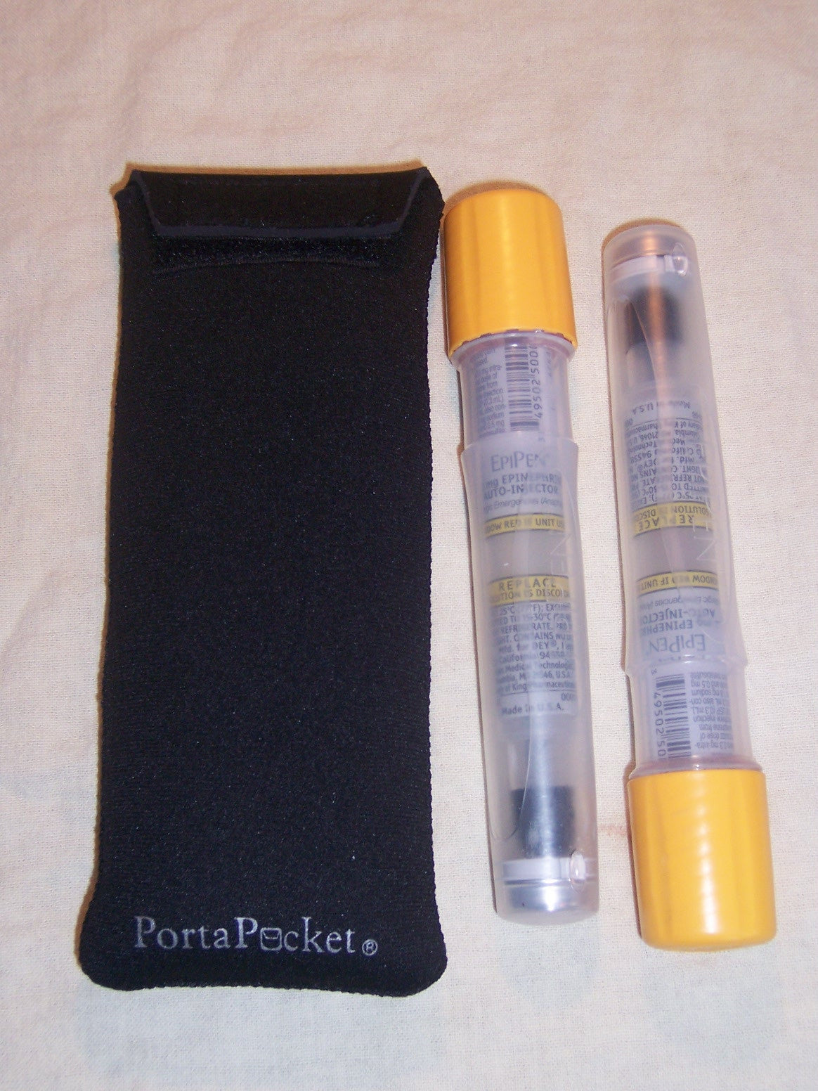 a black case and two tubes with a yellow cap