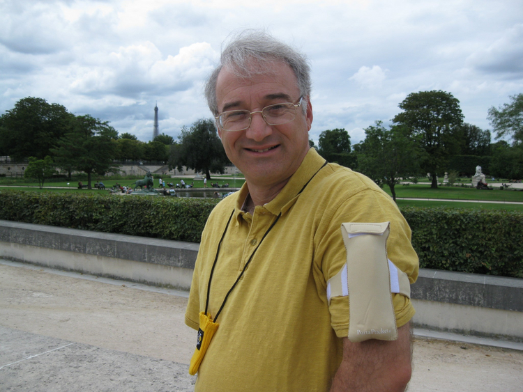 a man wearing a yellow shirt and glasses