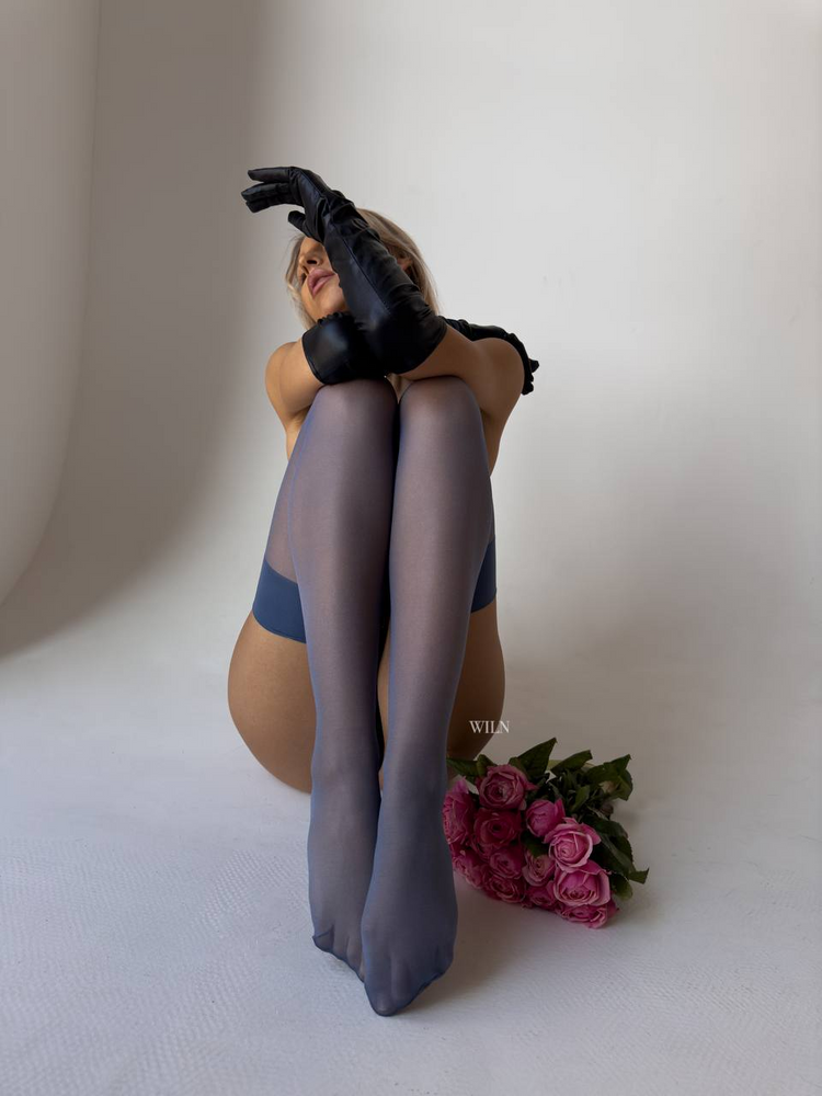 a woman sitting on the floor with her legs crossed