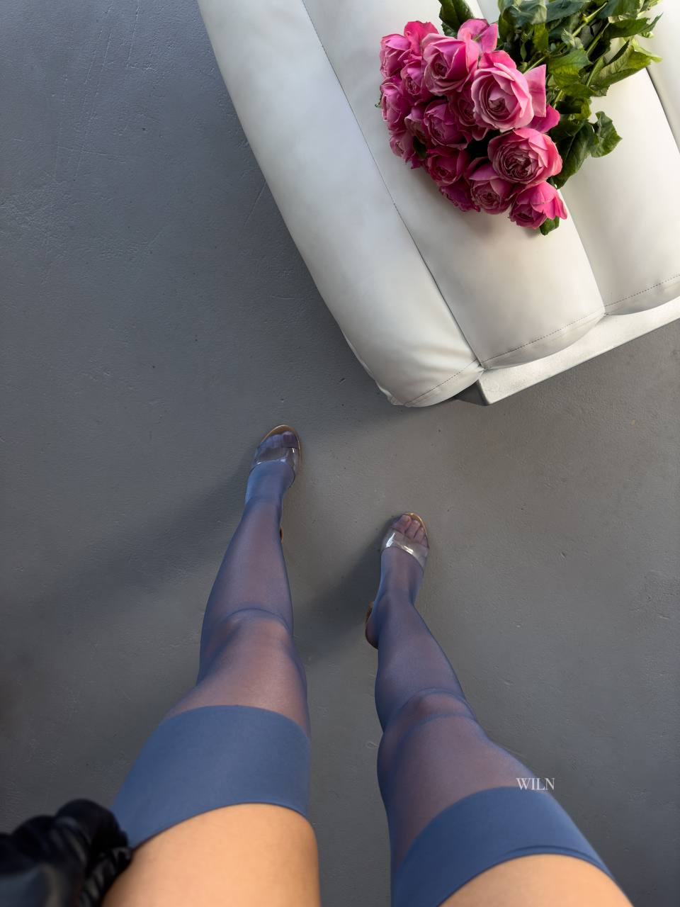 a person's legs and a bouquet of flowers