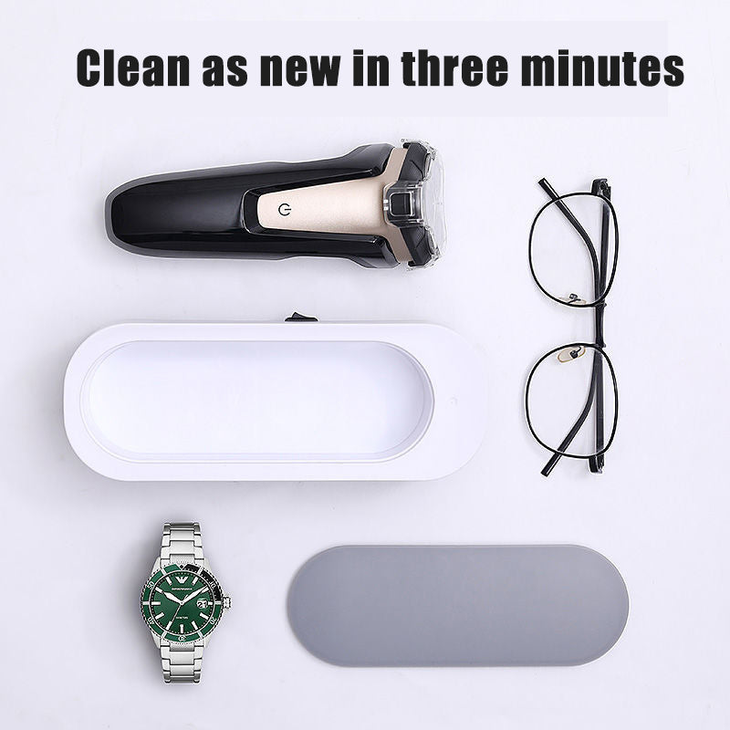 a watch and glasses on a white surface
