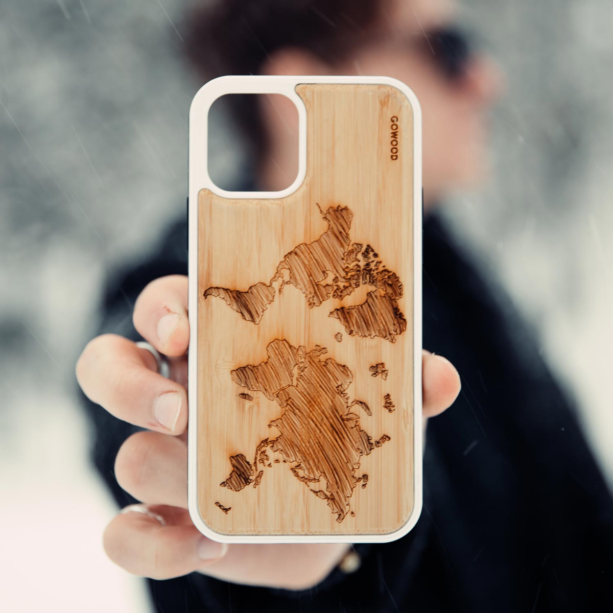 a person holding a phone case