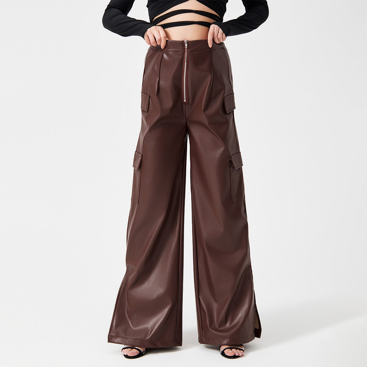 a woman wearing a black top and brown pants