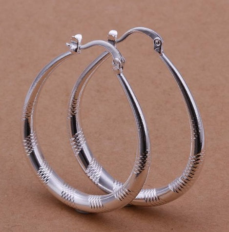 a pair of silver hoop earrings