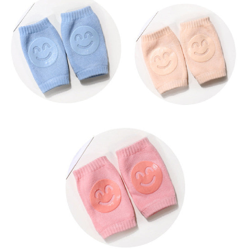 a pair of baby socks with smiley faces on them
