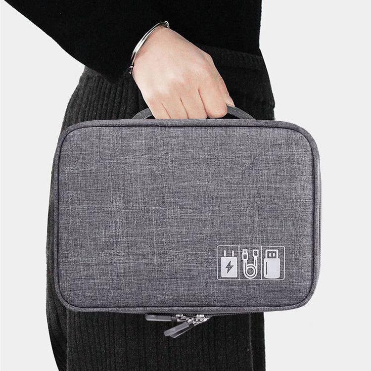 a person holding a small grey bag