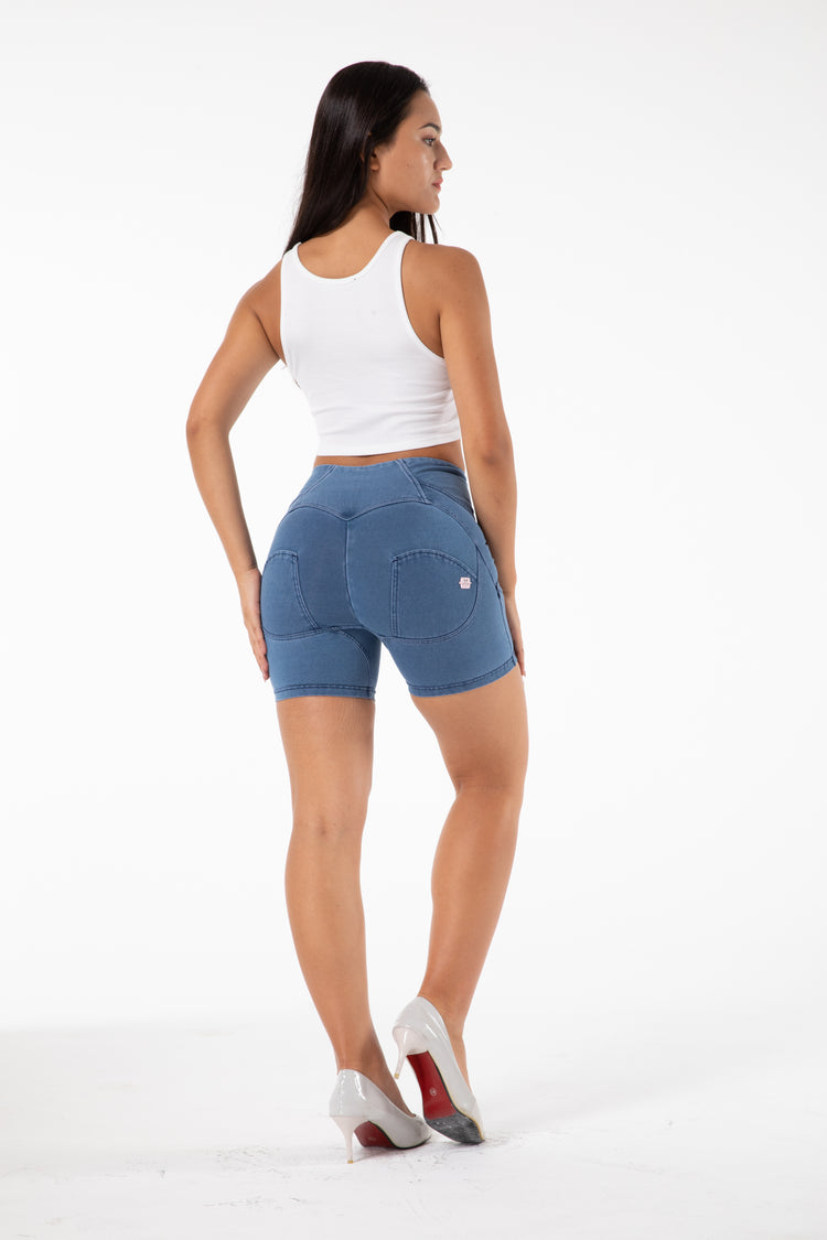 a woman in shorts and a white tank top