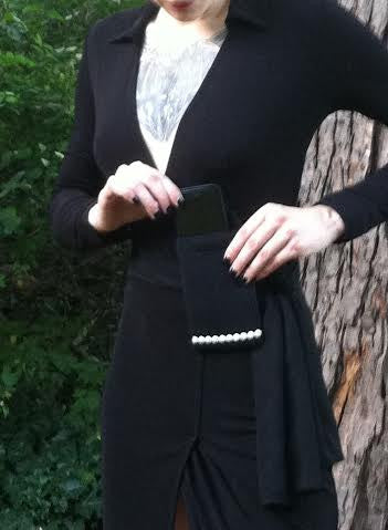 a woman holding a phone in her pocket