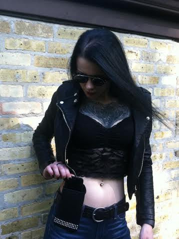 a woman in a leather jacket and sunglasses
