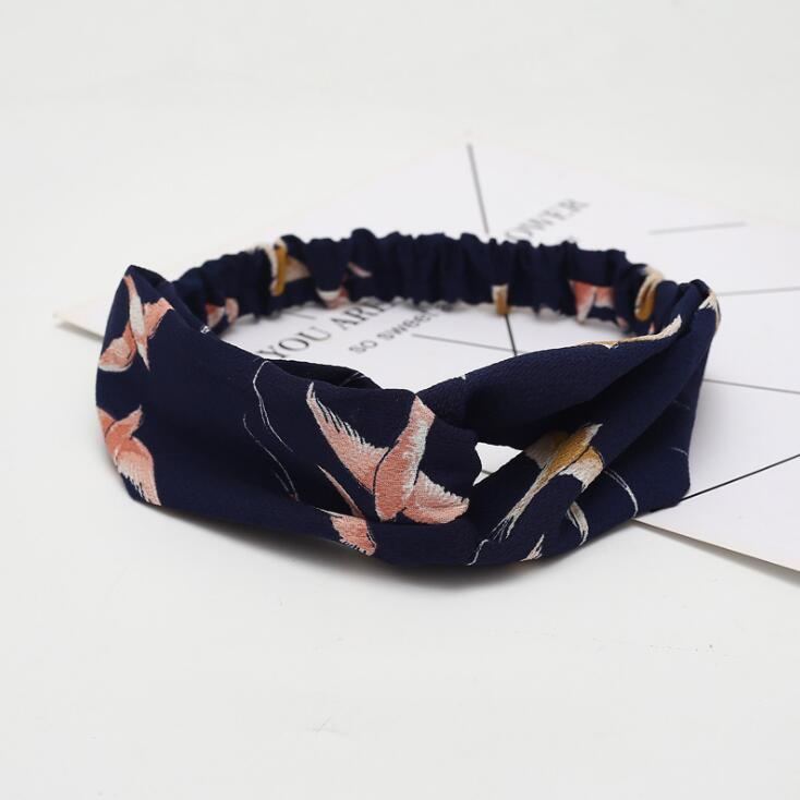 a blue headband with pink flowers on it