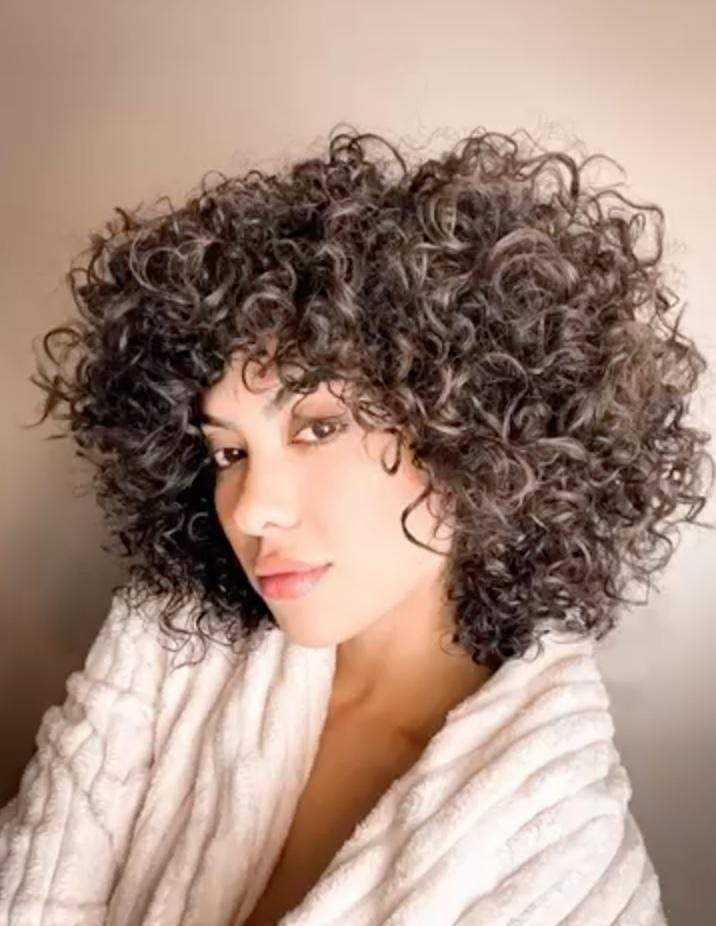 a woman with curly hair