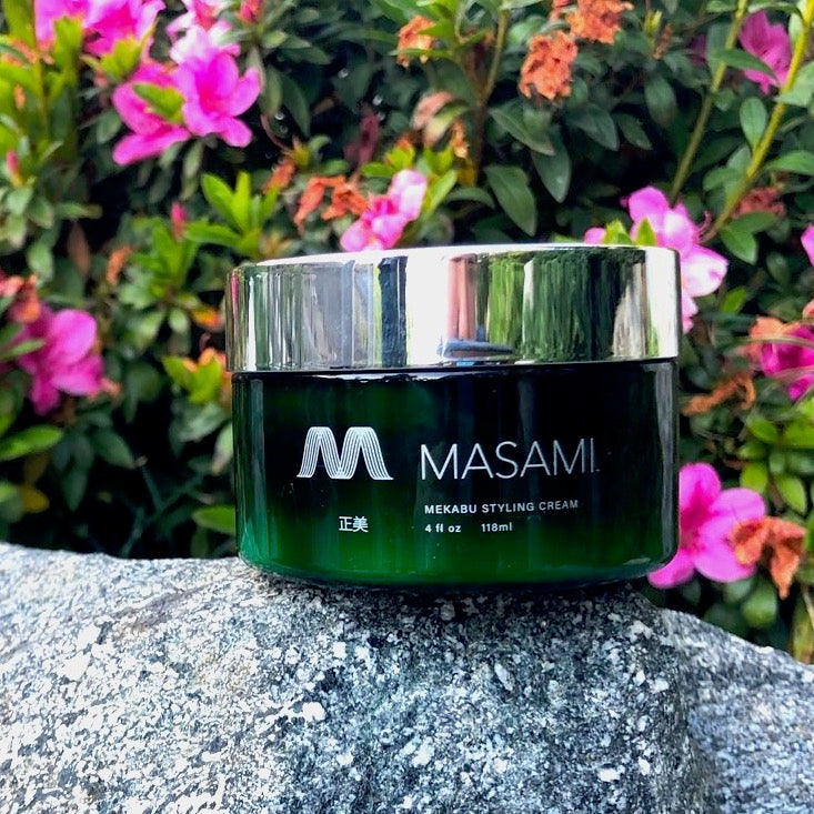 a jar of hair styling cream on a rock