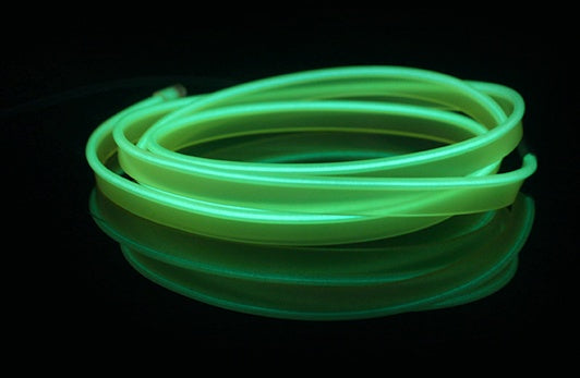 a green neon tube on a black surface