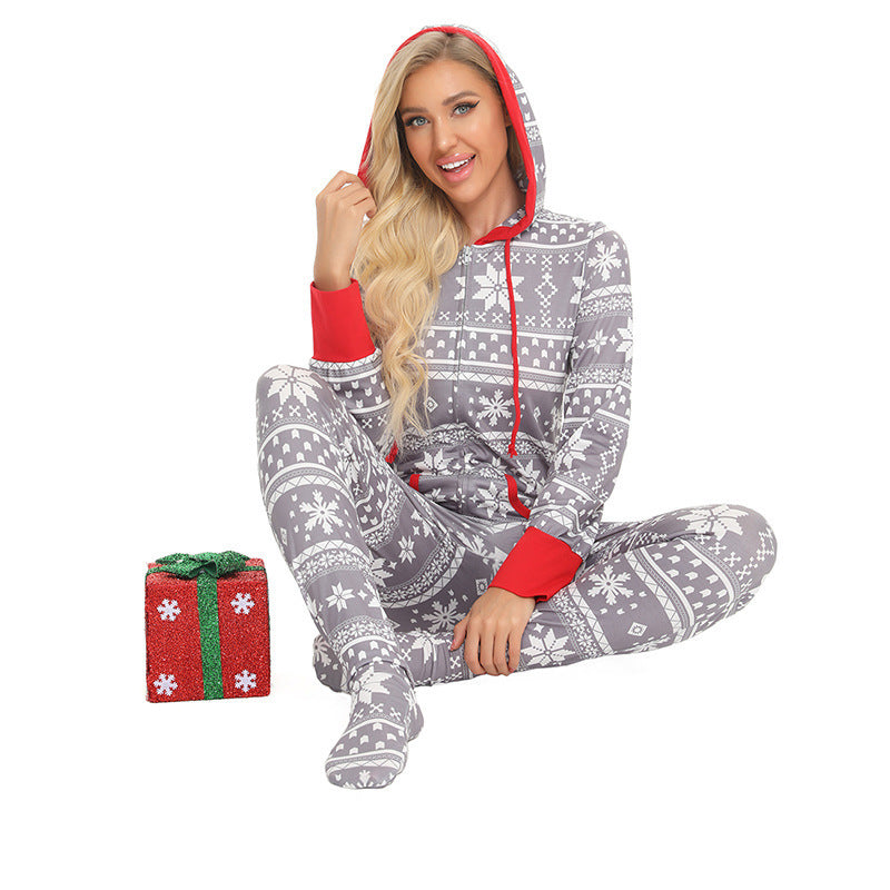a woman in pajamas sitting on the floor with a gift