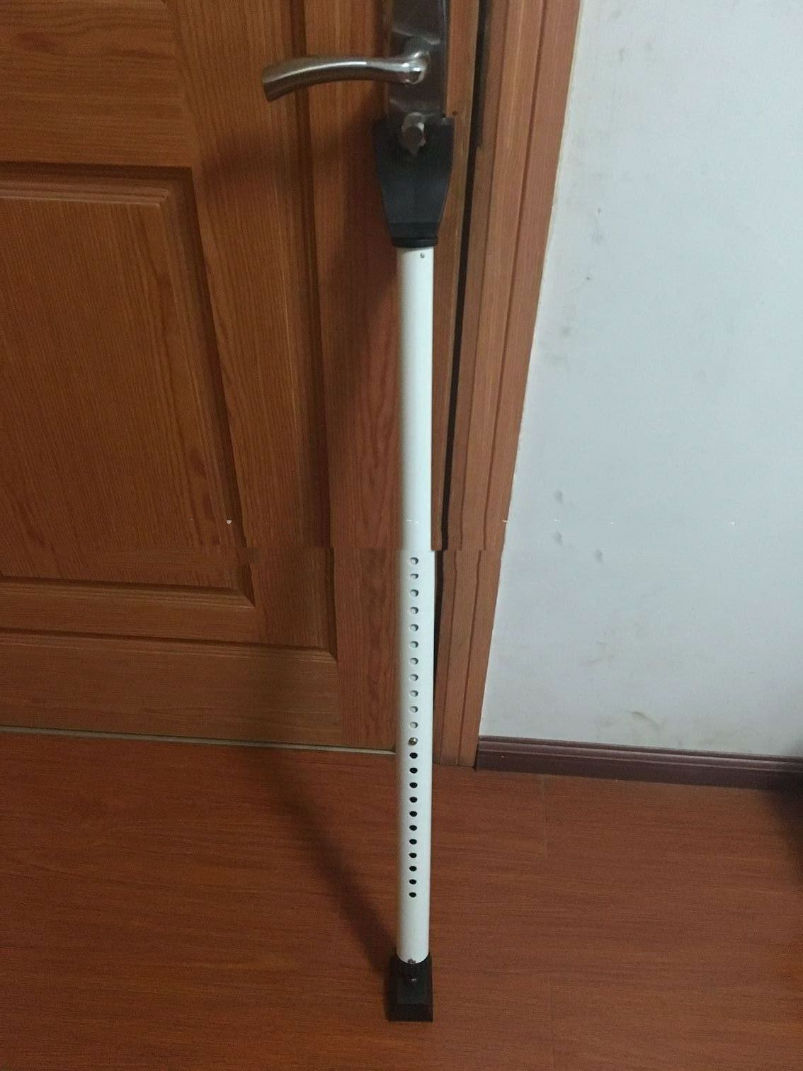 a white pole with holes on it