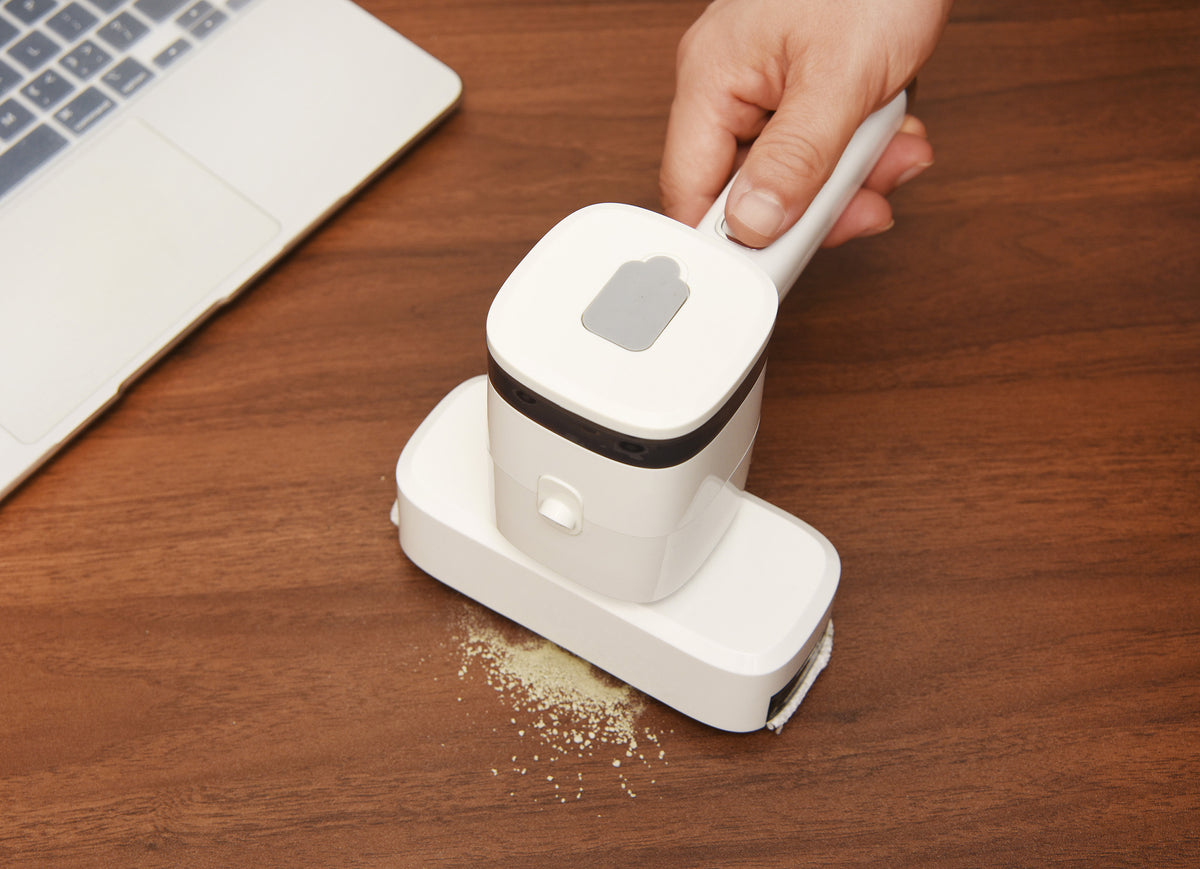 a hand using a vacuum cleaner