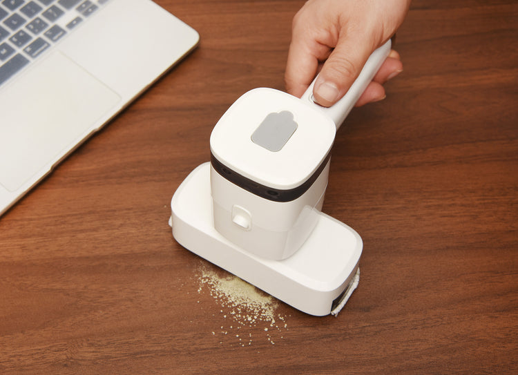 a hand using a vacuum cleaner