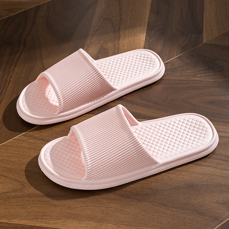 a pair of pink slippers on a wood floor