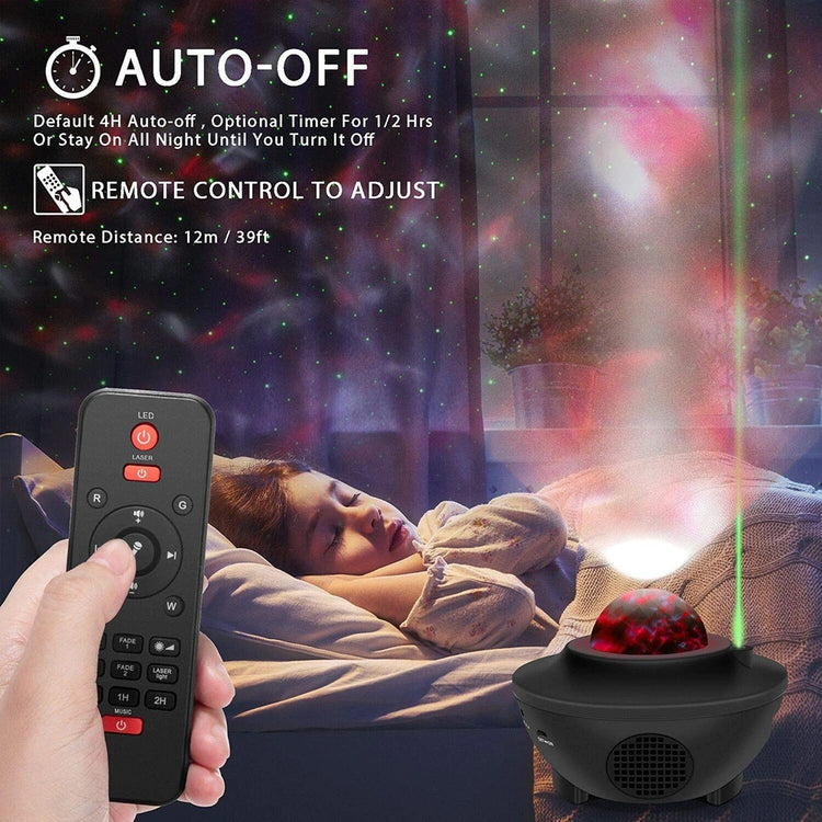 a hand holding a remote control and a child sleeping in bed