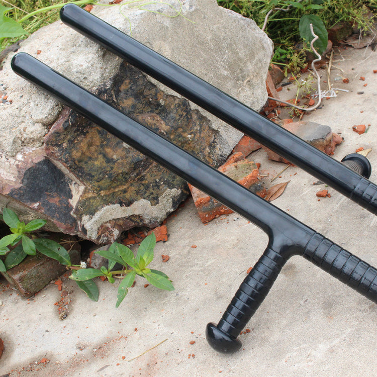a pair of black plastic sticks on a rock