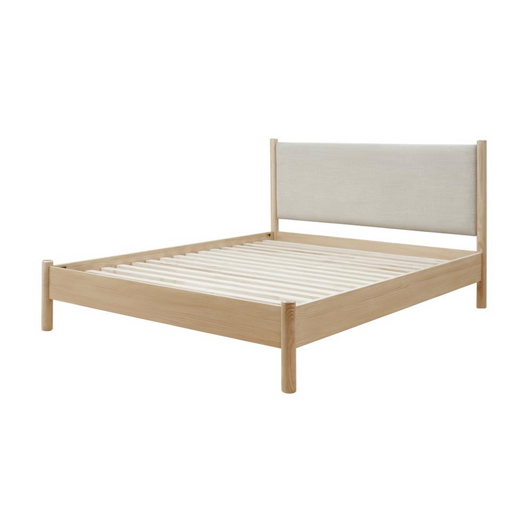 a wooden bed with a white headboard