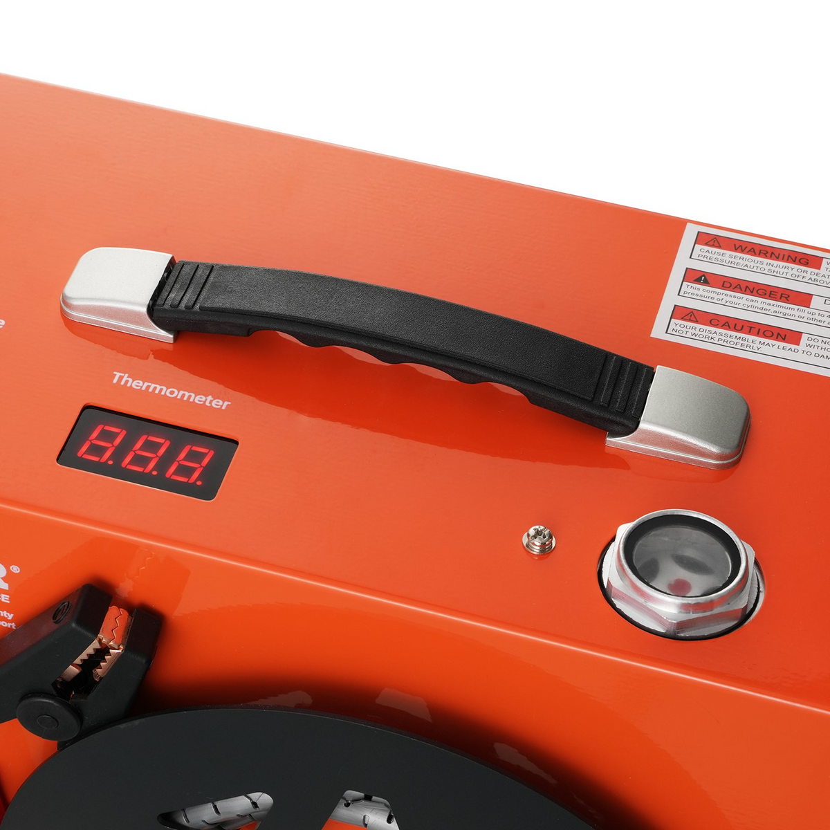 an orange thermometer with a black handle