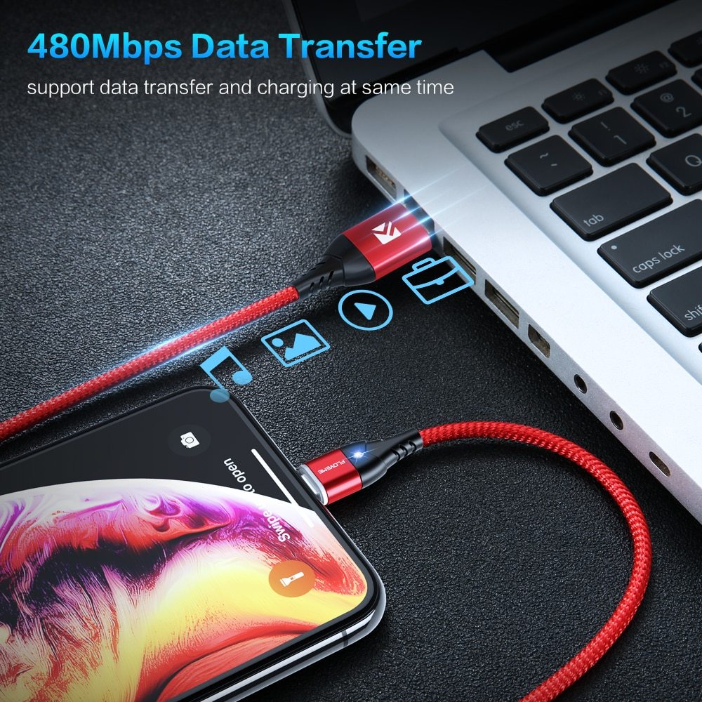 a cell phone charging on a laptop