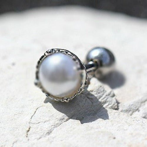 a pearl earring on a rock