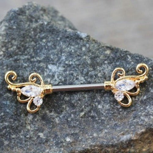 a gold and silver barbell on a rock