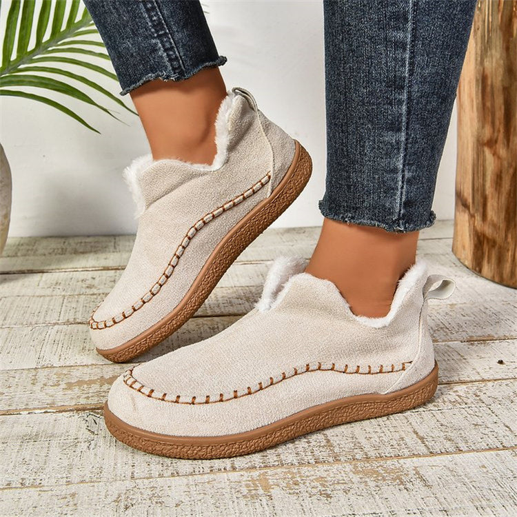 a pair of feet wearing white slippers