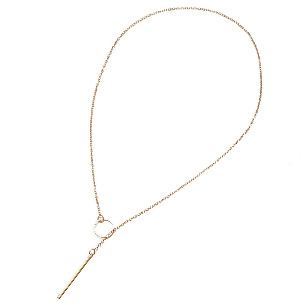a gold necklace with a bar on it