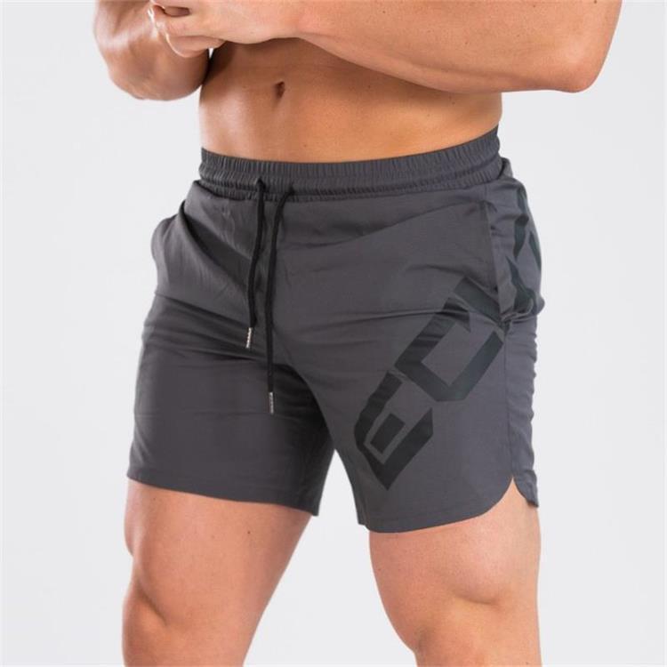 a man wearing shorts with his arms crossed