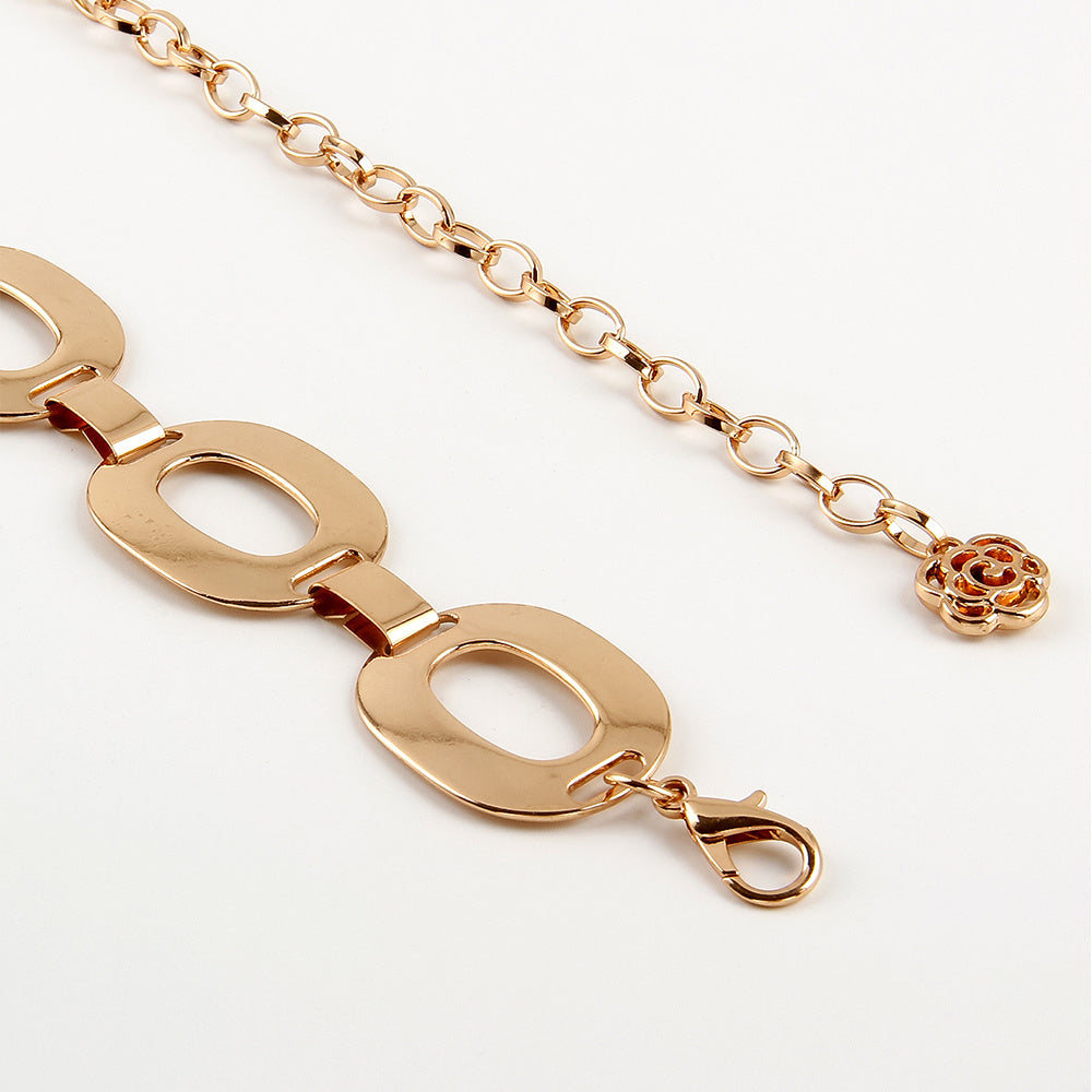 a gold chain with a flower on it