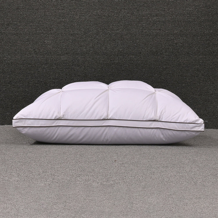 a white pillow on a grey carpet