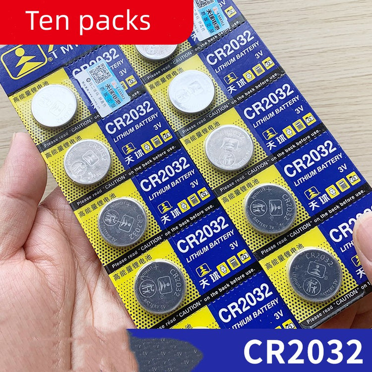 a hand holding a pack of batteries