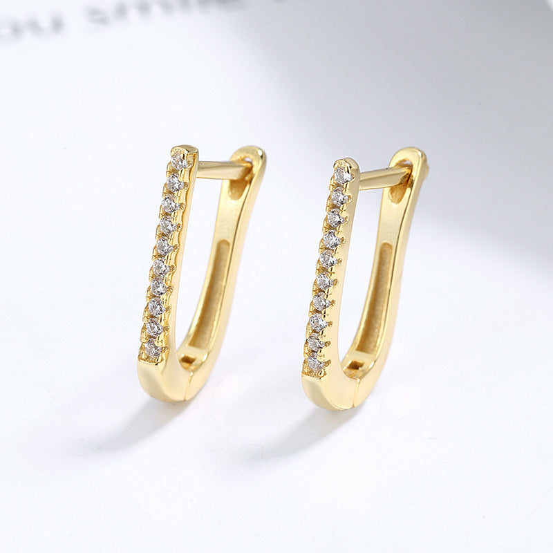 a pair of gold earrings with diamonds