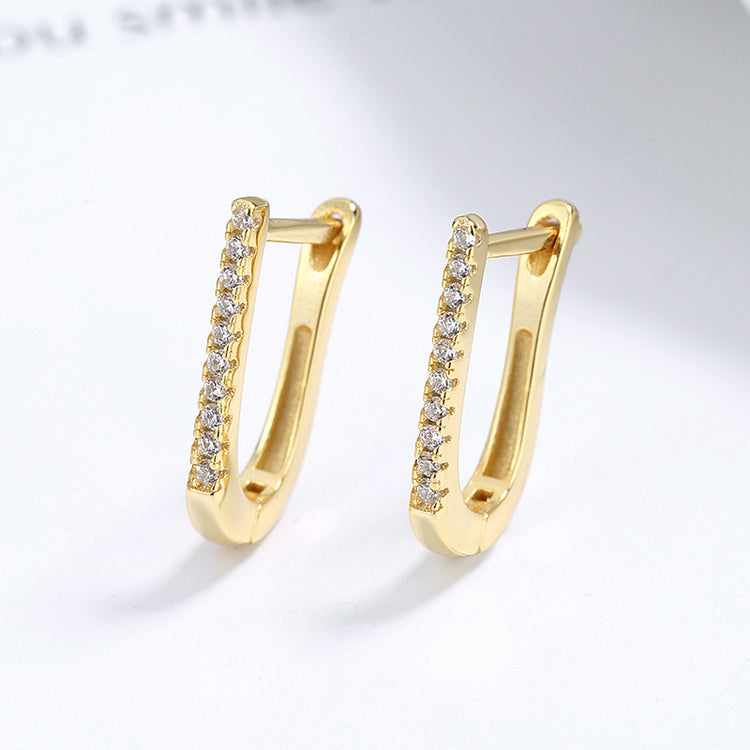 a pair of gold earrings with diamonds