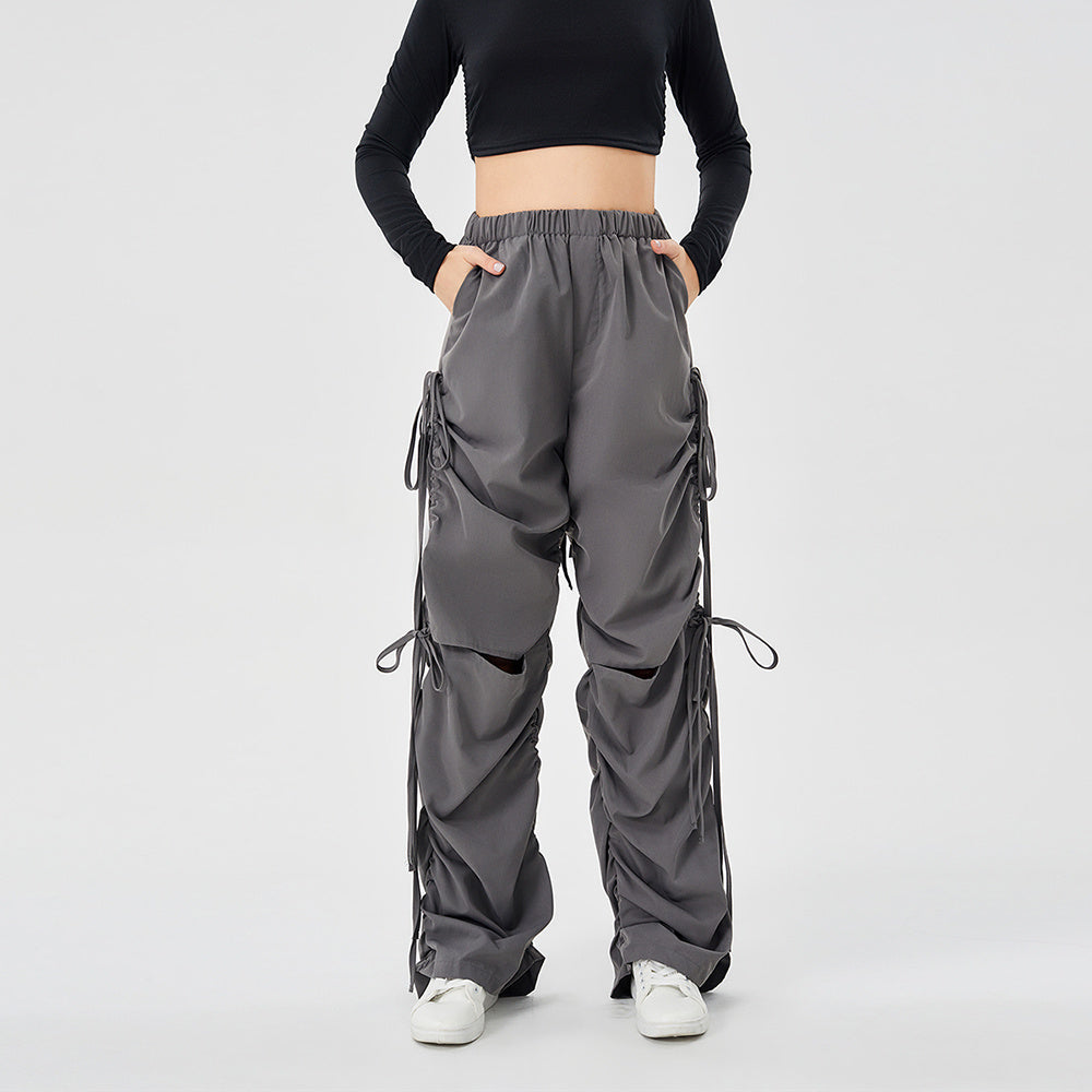 a person wearing a black top and grey pants